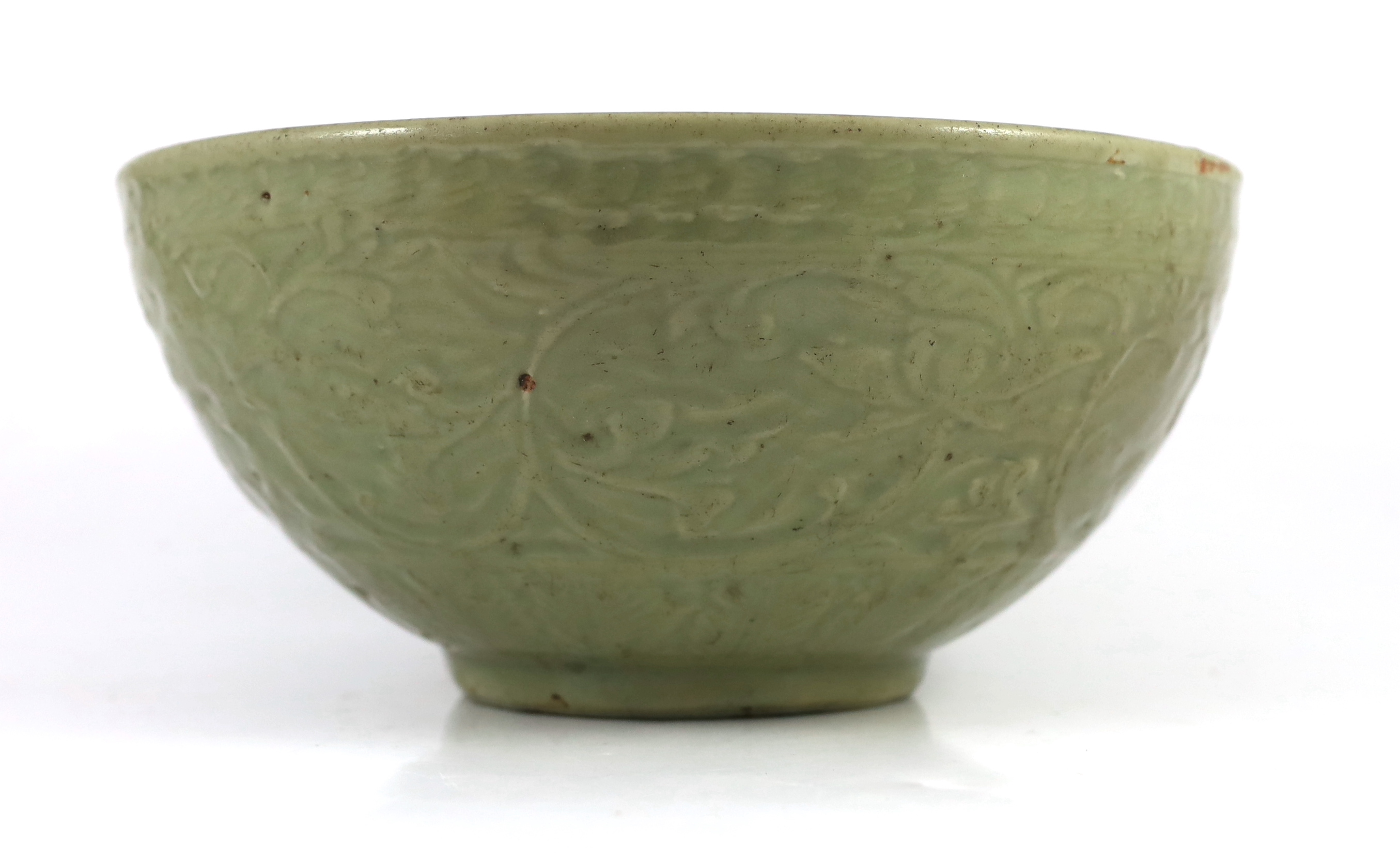 A large Chinese Ming carved Longquan celadon deep bowl, first half 15th century, scratches to glaze